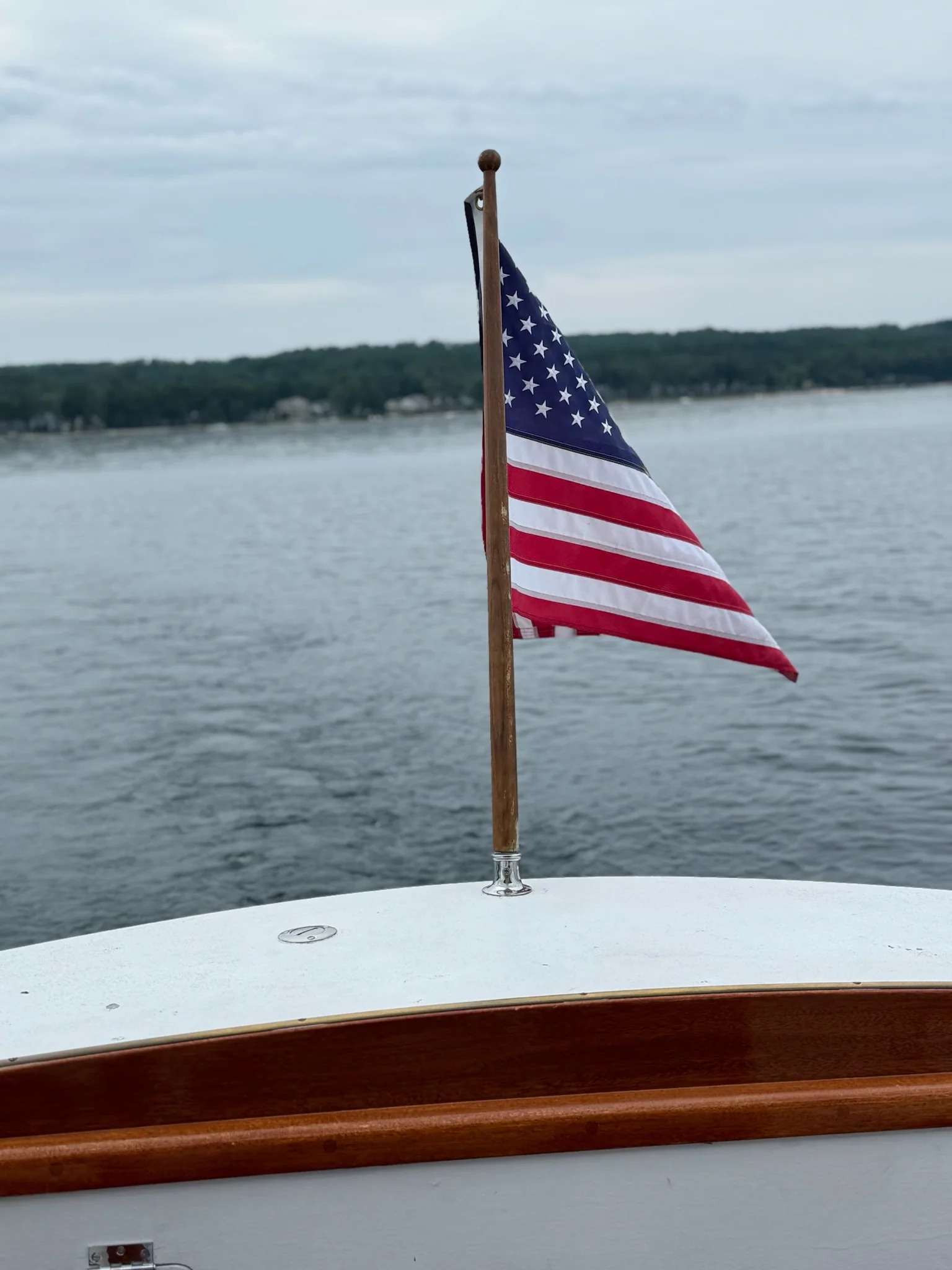 american flag on a boat on a lake